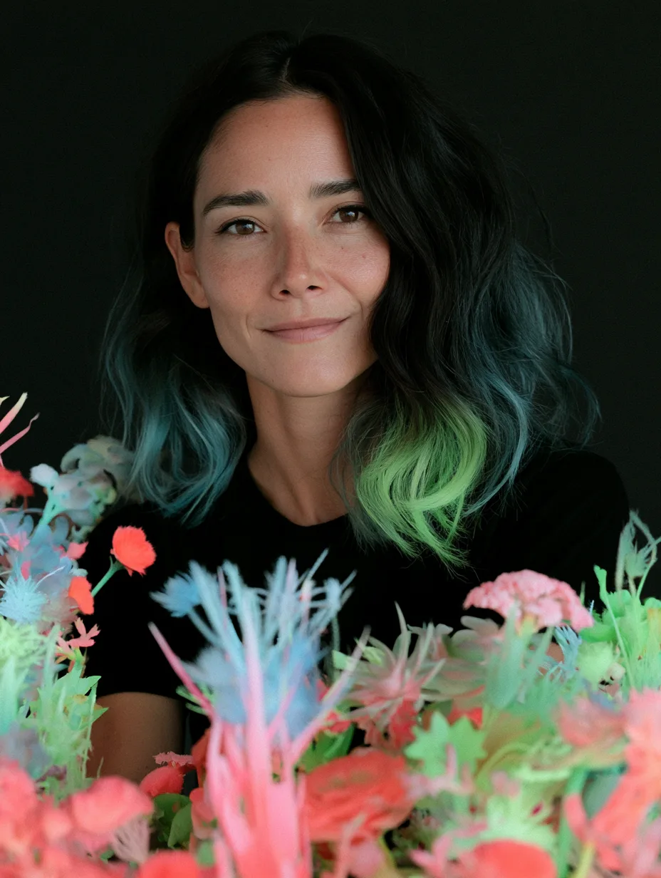 Art lead photographed in front of a bank of coloured props